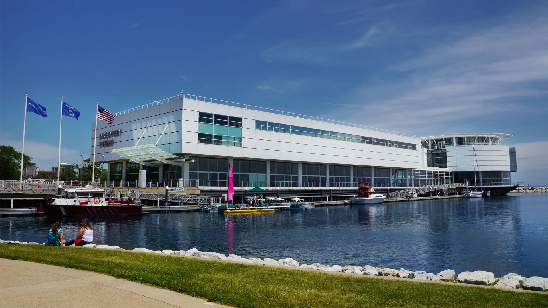 Discovery World museum on the Milwaukee lakefront with boats docked at the pier.