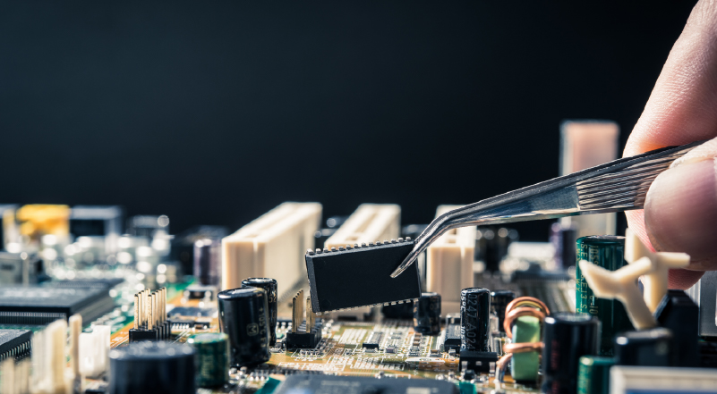 14 Precision tweezers placing a microchip onto a computer circuit board.