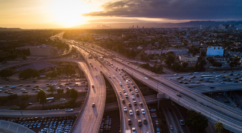 16 Busy freeway interchange in Los Angeles at sunset from an aerial view.